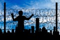 Silhouette refugee fence