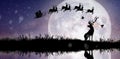 Silhouette of Santa Claus flying over the full moon