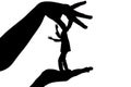 Silhouette female holding male by fingers behind the scruff as a puppet on white isolated background Royalty Free Stock Photo