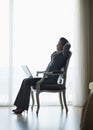 Silhouette of relaxed business woman in hotel room