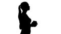 Silhouette Relaxed stylish businesswoman drinking coffee walking.