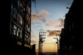 Silhouette of residential buildings and electricity transmission wires against the dramatic late afternoon sky Royalty Free Stock Photo