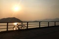 Silhouette retro bicycle and fence near ocean at sunset Royalty Free Stock Photo