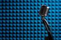 Silhouette of retro microphone on blue acoustic foam panel Royalty Free Stock Photo