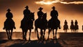 silhouette of riders A sunset with horse rider and shadows. The sunset is painted with orange and yellow, Royalty Free Stock Photo