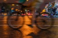 Silhouette of riding Cyclists on the city roadway, night light, bokeh, close-up of wheels and legs, abstract, motion