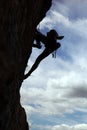 Silhouette of rock climber climbing a cliff Royalty Free Stock Photo