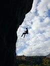 Silhouette of rock climber going down