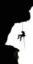 Silhouette of a rock climber on rappel