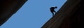 Silhouette of rock climber rappelling Royalty Free Stock Photo