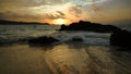 Silhouette Rock on the sand beach with Golden Sky Sunset