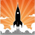 Silhouette of a rocket taking off against an orange background with stylized sun rays Royalty Free Stock Photo