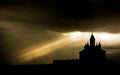 Silhouette of Romanian church with ray light after storm Royalty Free Stock Photo