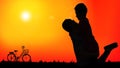 Silhouette of romantic couple having a happy time together after biking Royalty Free Stock Photo