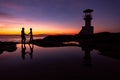 Silhouette Romantic couple with lighthouse at sunset time on background