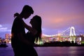 Silhouette romantic lovers with Odaiba