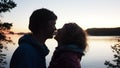 Silhouette of romantic talking couple of man and woman against sunset. Romance and active date happy people Royalty Free Stock Photo