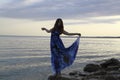 Silhouette of romantic woman standing on a rock by the sea dress Royalty Free Stock Photo