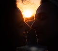 Silhouette of Romantic young couple kissing on sunset. Feelings, love and date concept Royalty Free Stock Photo