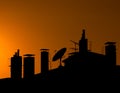 Silhouette of a Roof Top with Chimneys Royalty Free Stock Photo