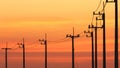 Silhouette row of many electric power poles in perspective curved line against colorful sunset sky Royalty Free Stock Photo