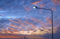 Silhouette row of street lampposts against colorful sunset sky background Royalty Free Stock Photo