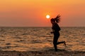 Silhouette runner feet running on the beach in the sunset outdoor. Asian fitness and sporty woman running for healthy and relax. Royalty Free Stock Photo