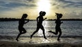 Silhouette of runner woman, running on the beach at sunset Royalty Free Stock Photo