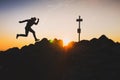 Silhouette of runner who run on the top of the hill during calm summer sunset - trail run in mountains, concept photo with copy