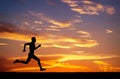 Silhouette of running man on sunset background Royalty Free Stock Photo