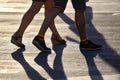 Silhouette running two pairs of legs in backlight sunlight
