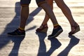 Silhouette running two pairs of legs in backlight sunlight