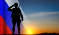 Silhouette of russian soldier on background of sunset