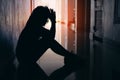 Silhouette of sad and depressed women sitting at walkway of condominium or office Royalty Free Stock Photo