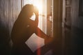 Silhouette of sad and depressed women sitting at walkway of condominium or office