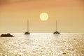 Silhouette of sailboat with sunset or sunrise