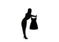 Black silhouette of a salesgirl showing a dress to a customer, saleslady, saleswoman, and shopgirl.