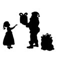 Silhouette Santa Claus giving girl present. Royalty Free Stock Photo