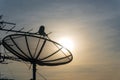 Silhouette of satellite dish on the roof for communication and television on beautiful sunset sky Royalty Free Stock Photo