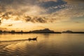 Silhouette scene of long-tail boat morning sunrise