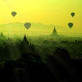 The silhouette scenic sunrise with silhouette balloons above ruin pagoda in Bagan, Myanmar.
