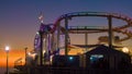 SILHOUETTE: Scenic view of the amusement park on Santa Monica pier at sunset. Royalty Free Stock Photo