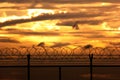 Silhouette security with a barbed wire fence