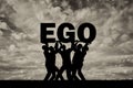 The silhouette of a selfish crowd holds the word ego Royalty Free Stock Photo