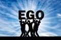 The silhouette of a selfish crowd holds the word ego. Royalty Free Stock Photo