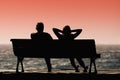 Silhouette seniors couple waiting for colourfull sunset