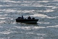 Silhouette of several fishermen fishing in rough waters Royalty Free Stock Photo