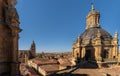Silhouette and shadow of the dome with its cross projected on the roof of the Clerecia tower in Salamanca and view of the city and