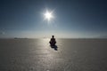 Yoga Silhouette and shadow of a person in bright sunshine and blue sky in the vastness of the dry Salt Flats of Uyuni, Bolivia