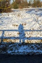 Silhouette, shadow of a woman and a bridge railing in the snow Royalty Free Stock Photo